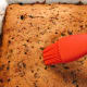 Brush the cake with the strained juice or orange juice.