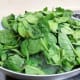 Add the fresh spinach leaves to the pan with the onions.