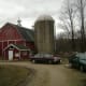 The milkhouse is the small red building in front of the barn. Taken in 2010.