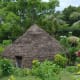 Traditional round grass hut. most of the native people now live in basic houses, but a number still have kept the original huts on their land as well.