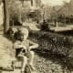 Here she is riding with dog Jiggs on the back of her tricycle.