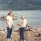 The next day, the children learned to fish on the shore of the lake. The neighbor in the next cabin showed them how.