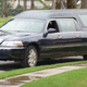 Hearse arrives at grave site.