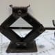 Scissors jack. This type of scissor-action is usually seen as an automobile jack; useful for those flat-tire episodes