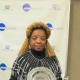 The widow of Walker Carter poses with the award in memory of her husband who caught a 70-yard touchdown reception for a National Championship game that sealed the 1977 Division 111 championship for Widener University.