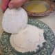 First dip the slice into the flour.