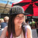 Me sitting at an outdoor table with a beautiful red umbrella in the background.