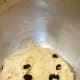 The dough and the raisins are well-combined and ready to be transferred.
