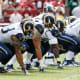 Offensive linemen block for the QB and RB. The Center, who hikes the ball, can be seen in the middle.