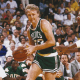 Larry Bird dribbling all the way towards the basket.