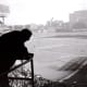 A retired Joe DiMaggio looks out from the press box at Yankee Stadium during Game 1 of the 1957 World Series. This is a brilliant photo that speaks to the viewer. Recently divorced from Marilyn Monroe, he was at a crossroads in his life.