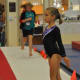 Gymnast at attention - awaiting start of Level 5 floor routine