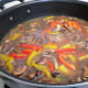 Add the Marsala wine and chicken broth to all of the vegetables