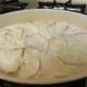 Half of the béchamel sauce over the potatoes and onions