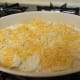 1/2 cup of cheese is spread next.