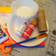 The supplies to make a toilet paper roll apple core.