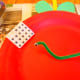 Create a wiggly worm to poke through the center of the apple.