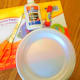 The supplies to make a construction paper apple.