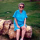 My mother waiting at the bottom of the trail sitting on a piece of petrified wood