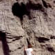 My niece is knocking on a petrified sand dune. It sounds hollow!