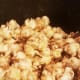 Continue stirring until all kernels are covered.