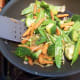 Stir fry vegetables in non-stick pan. Use non-stick spray or 1 tea. sesame oil for flavor. When vegetables are cooked, take out of pan and set aside.