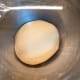 Transfer the dough into a greased bowl and cover with a cling wrap.
