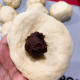 Take the chocolate filling and put it in the center of the dough.