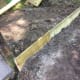 Hardware cloth and pressure-treated wood around the base