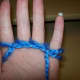 Wrap yarn around back of little finger, letting it hang over palm.