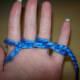 Wrap yarn back and around little finger.