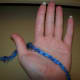 Palm facing you, yarn between thumb and pointer finger, tail behind hand.