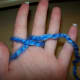 Wrap yarn back and around middle finger.