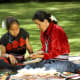 Navajo woman and girl, sharing culture.