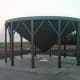 Later the hopper is moved into position on a cured concrete slab, where anchor bolts are installed in each of its feet.