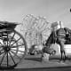 This picture of Blackpool Pleasure Beach was taken between 1946 and 1955, it is one of the most popular attractions in England, and offers rides such as the double ferris wheel seen here. A horse-drawn carriage along the promenade provides a more sed