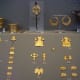 Fine gold jewelry, including butterflies and stylized buildings, from Mycenae.