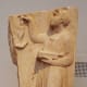 Young girl gives up her doll to Artemis, a ritual that traditionally occurred just before marriage. The gravestone suggests she died at puberty.