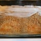 #6- Add a thin layer of nuts. Approximately 1/3 cup. Then begin to lay crumpled layers of Fillo to fit your pan. Usually, 4-5 fillo will work.