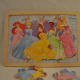 12-piece Disney Princesses interlocking puzzle, with identical background.