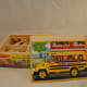 Boxed set of four 9-piece puzzles. No pictures of puzzles except small illustrations on side of storage box.