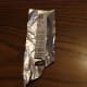 Cover the two stiff cardboard strips in a single layer of aluminum.