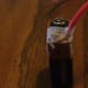 Attach the stripped end of one copper wire to the positive end of the battery.