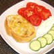 Bruschetta and salad is plated, ready for meat from chicken legs