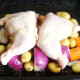 Chicken legs are laid on the vegetable bed
