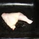 Chicken leg is oiled and salted