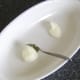 Spooning goose fat in to roasting dish
