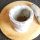 Toasted mustard and cumin seeds are ground with a pestle and mortar