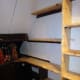 Two replacement wall shelves, test fitted with the other shelving positioned.