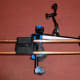 Shoulder Rig adjusted for left shoulder with camera plate on top, hand grips below and articulating arm and support clamp on the right.